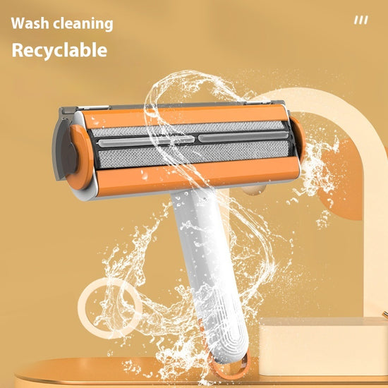 Self-cleaning pet hair remover brush on black fabric
